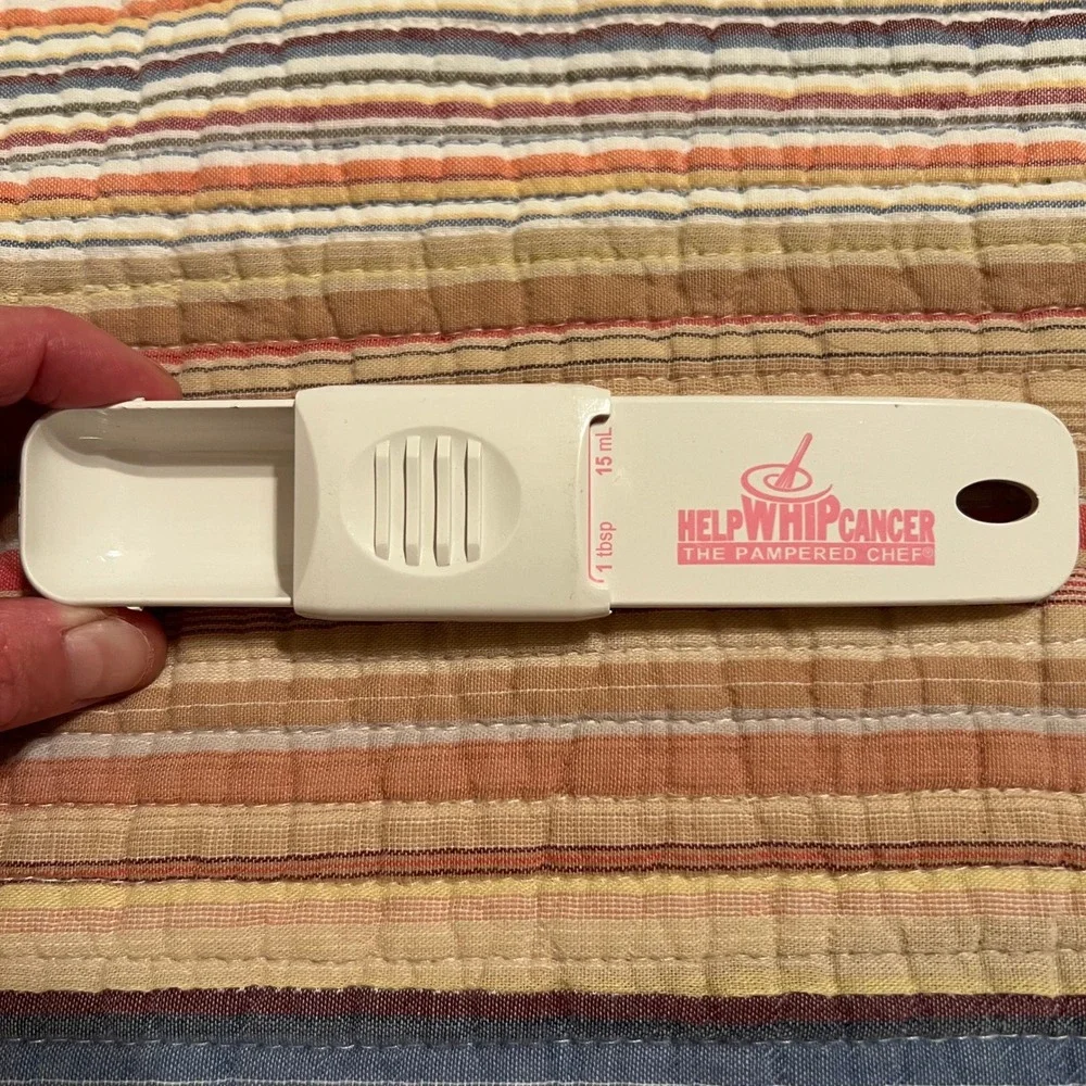 The Pampered Chef Help Whip Cancer Adjustable Measuring Spoon White Pink